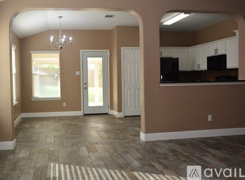 A kitchen area with a counter and cabinets.