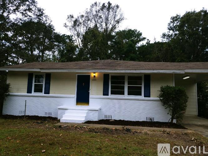 A white house with a blue door and windows.