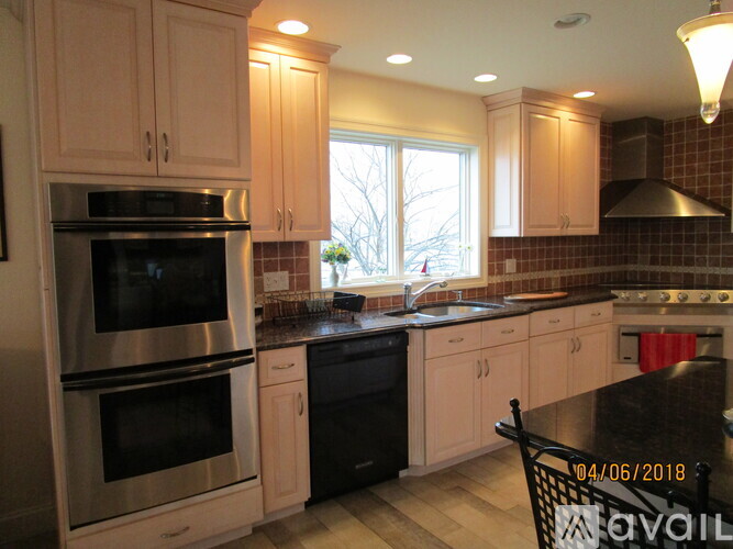 A kitchen with a black stove top oven and a black dishwasher.