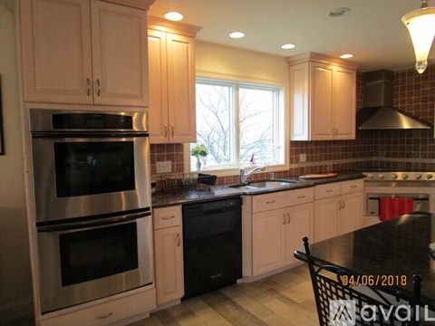 A kitchen with a black stove top oven and a black dishwasher.