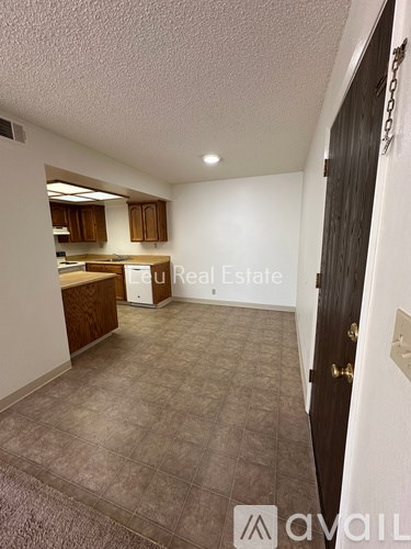A room with a kitchenette and a countertop.