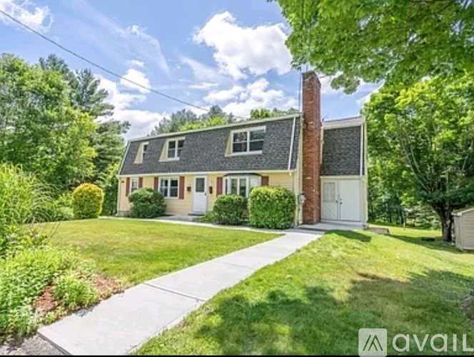 A house with a brick chimney is for sale.