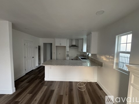 A kitchen area with a countertop and cabinets.