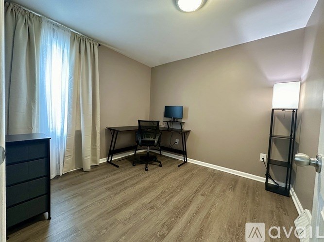 A room with a desk and a chair.