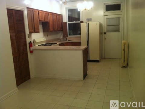 A kitchen with white appliances and wooden cabinets.