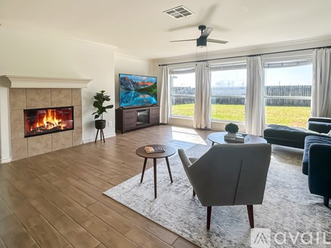 A living room with a fireplace and a painting on the wall.