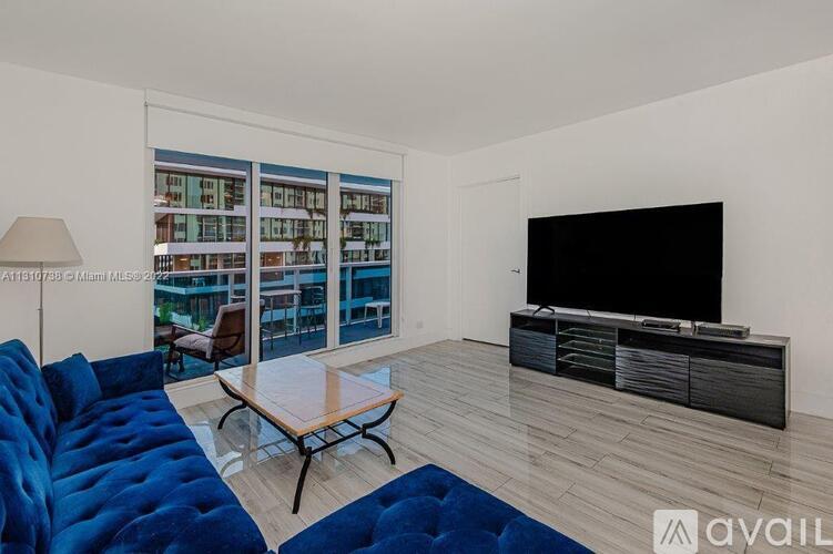 A living room with a blue sofa and a television.