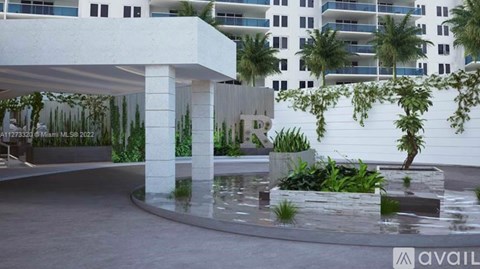A white building with a pool in front of it.