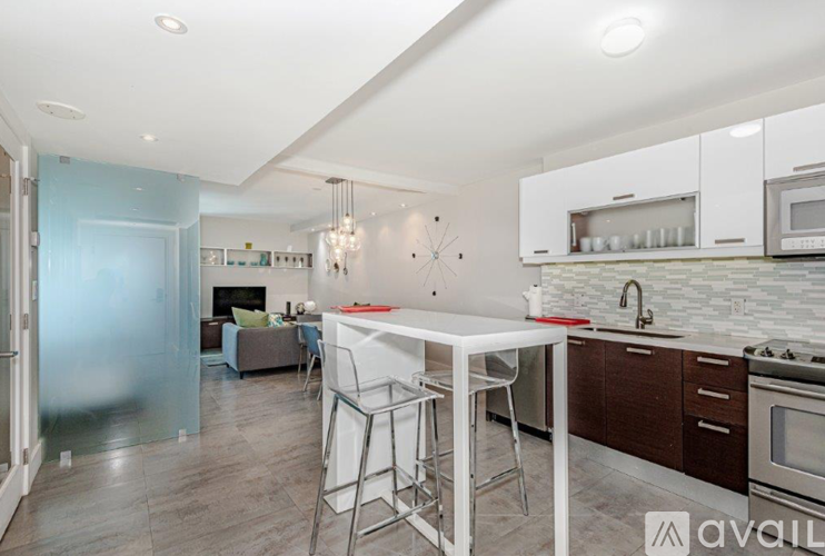 A kitchen with a white table and chairs and a blue wall.