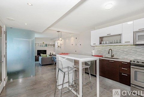 A kitchen with a white table and chairs and a blue wall.