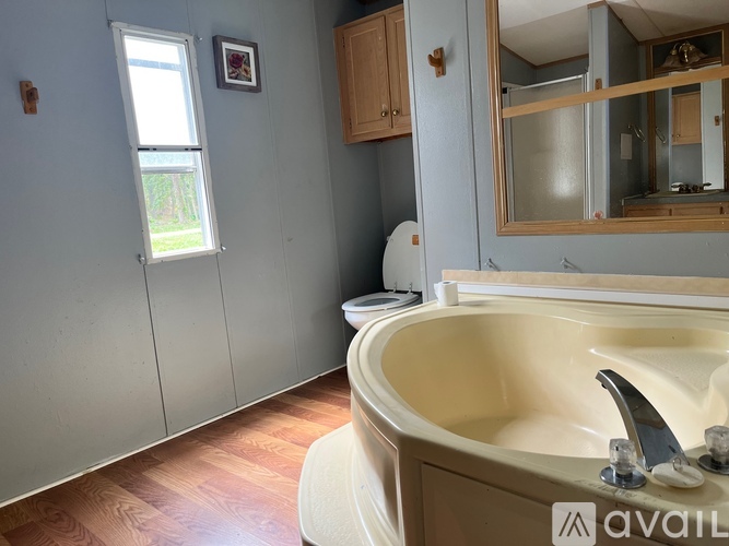 A bathroom with a tub, toilet, and sink.