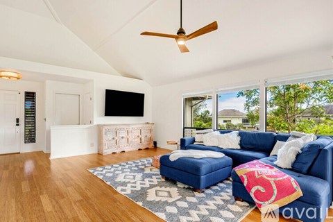 A living room with a blue couch and a television.