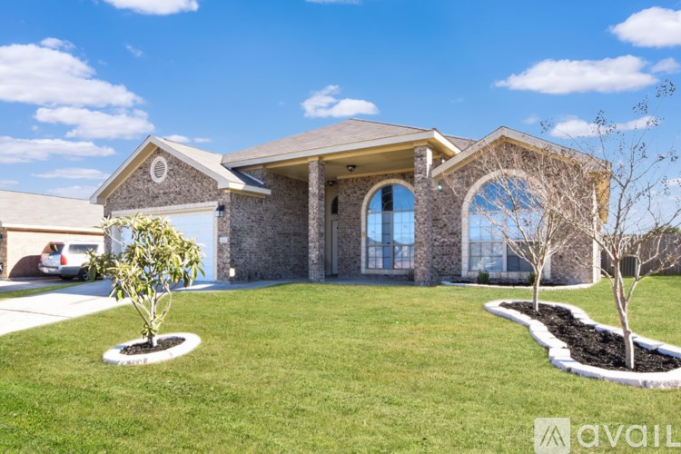 A house with a garage and a driveway in front.