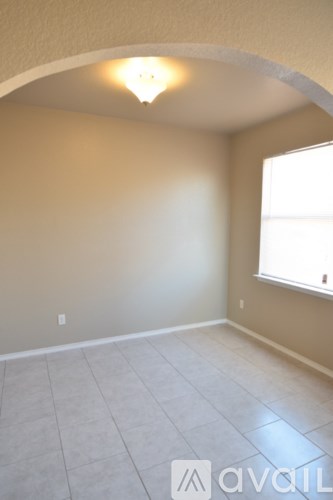 A room with a fan and a window.