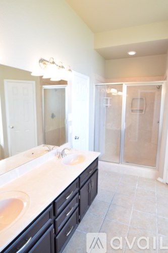 A room with a ceiling fan and a doorway leading to another room.