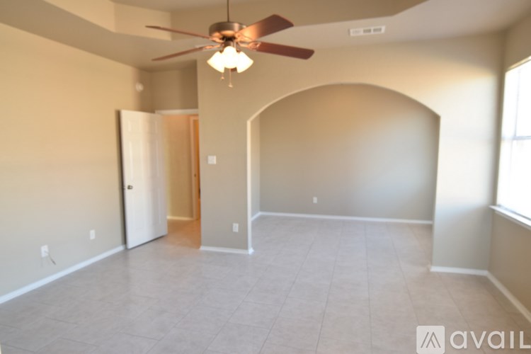 A room with a light on the ceiling and a window on the wall.