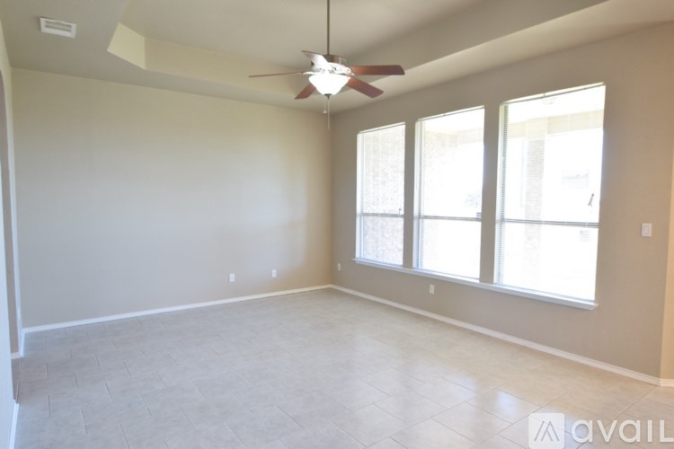 A bathroom with a white door, a sink, and a mirror.