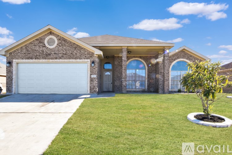 A house with a stone facade and a white garage door.