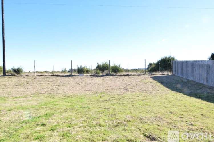 A field with a wooden fence on the right side.