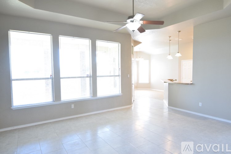 A room with a large window and a chandelier.