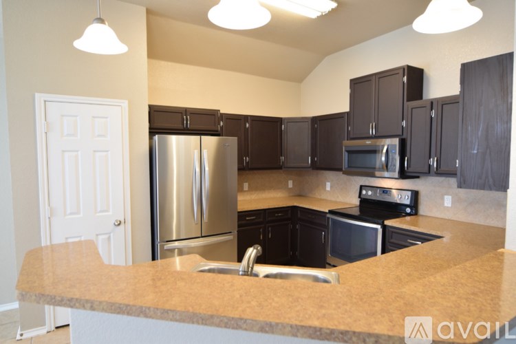 A spacious room with a fan and large windows.