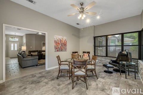A living room with a dining table and chairs.