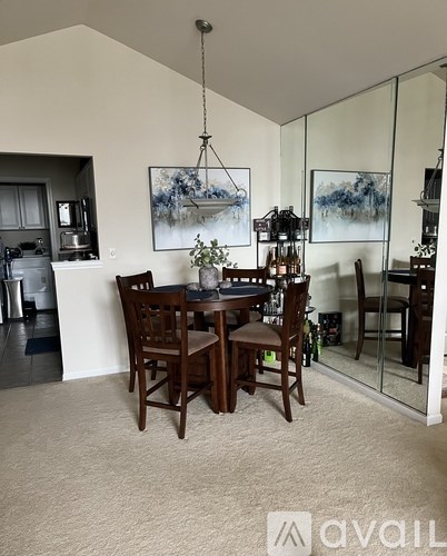 A dining room with a table set for four.