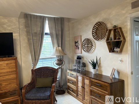 A living room with a chair, a cabinet, and a television.