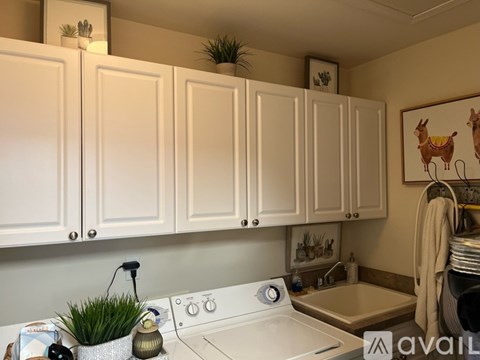 A kitchen with white cabinets and a white stove top oven.