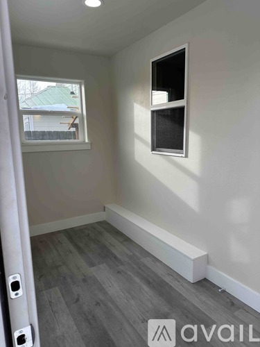 A room with a window and a wall socket.