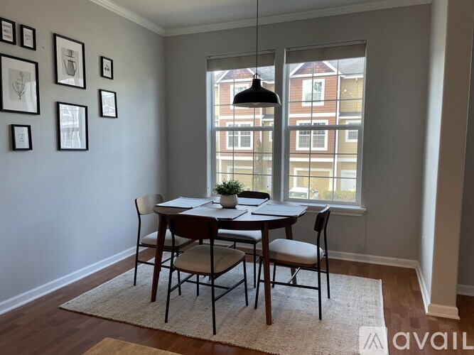 A dining room with a table set for four.