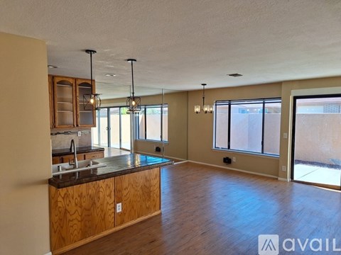 A kitchen with wooden cabinets and a countertop is available for rent.