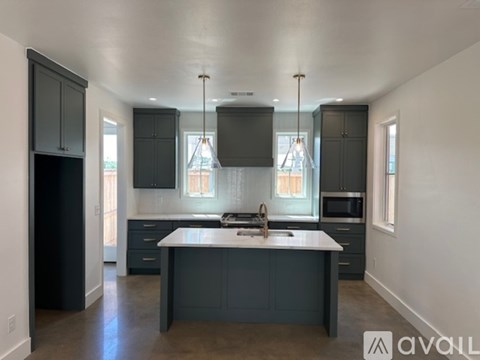 A kitchen with a large island in the middle.