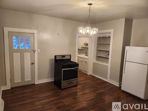 A kitchen with a black oven and white cabinets.