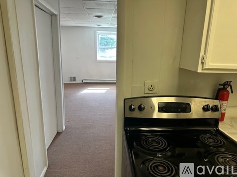 A kitchen with a stove and a window.