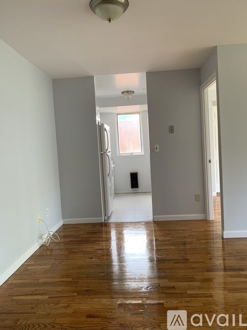 A room with wooden floors and a window.