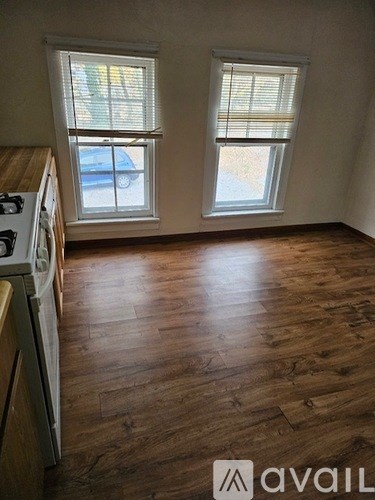 A kitchen with a stove top oven and a window.