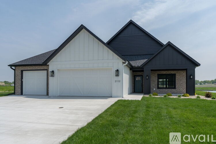 A two-story house with a garage is available for sale.