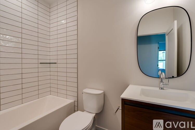A bathroom with a white toilet, a white sink, and a white bathtub.