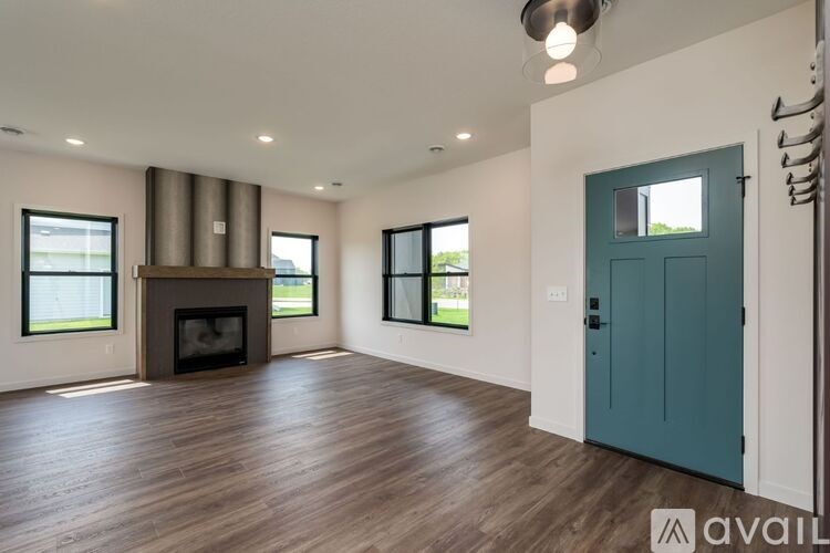 A spacious living room with a fireplace and hardwood floors.