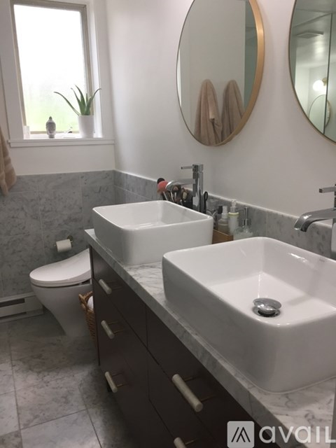 A bathroom with two sinks and a toilet.