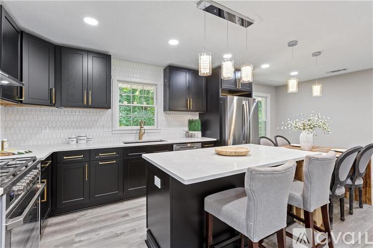 A kitchen with dark blue cabinets and a wooden countertop.