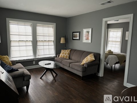 A living room with a grey couch and a coffee table.