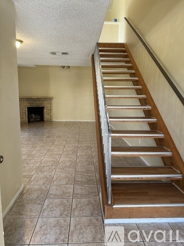 A staircase with a metal railing and wooden steps.