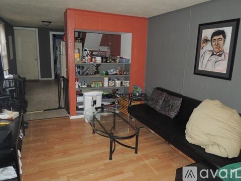 A living room with a black couch and a coffee table.