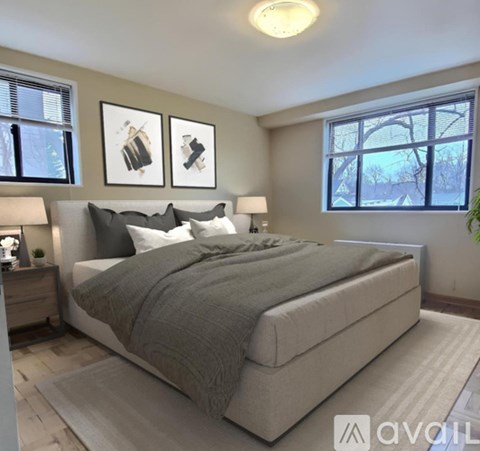 A bedroom with a large bed and two lamps.