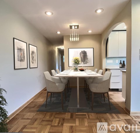 A dining room with a table set for six.