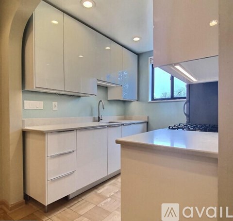 A kitchen with white cabinets and a countertop.