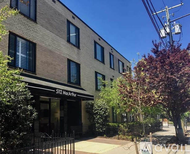 The image shows a building with the number 5112 and the name MacArthur on it.