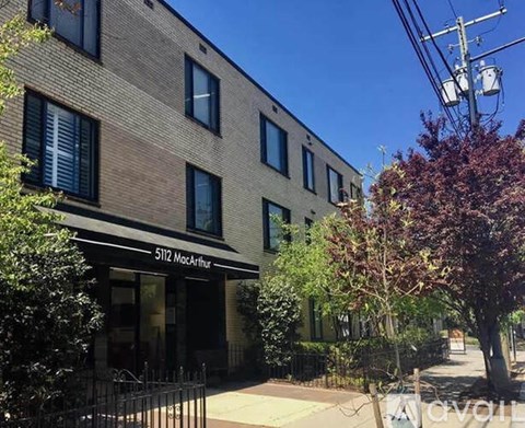 The image shows a building with the number 5112 and the name MacArthur on it.